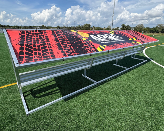 Bench with a red and black design on a sports field